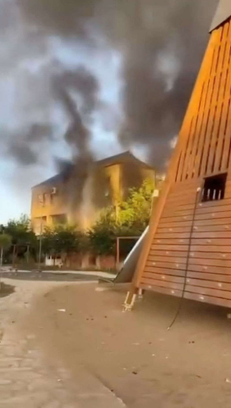 A view shows plumes of smoke rising from building, in Derbent, Russia, 23 June 2024, in this still image obtained from a video.