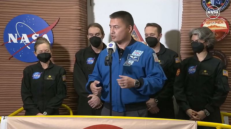 In this still image taken from a NASA TV broadcast on 6 July, NASA astronaut and deputy director, Flight Operations Kjell Lindgren (C) speaks as volunteer crew members (L-R) Kelly Haston, Ross Brockwell, Nathan Jones and Anca Selariu, exit the first simulated yearlong Mars habitat mission at Johnson Space Center in Houston, Texas