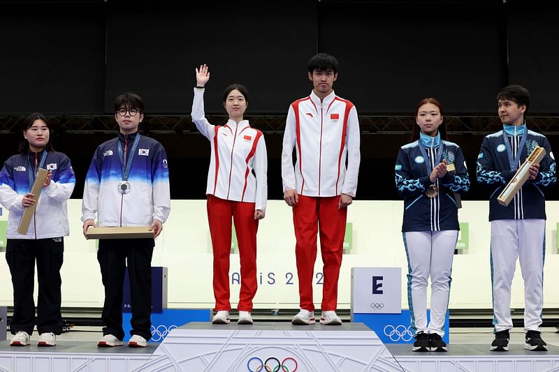 Gold medalists Yuting Huang and Lihao Sheng of Team People’s Republic of China (C), Silver medalists Hajun Park and Jihyeon Keum of Team Republic of Korea (L) and Bronze medalists Alexandra Le and Islam Satpayev of Team Kazakhstan (R) pose on the podium during the Shooting medal ceremony after the 10m air rifle mixed team during the Paris 2024 Olympic Games at Chateauroux Shooting Centre on July 27, 2024