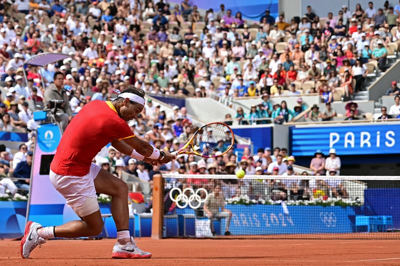 Spain's Rafael Nadal returns to Hungary's Marton Fucsovics during their men's singles first round tennis match on Court Philippe-Chatrier at the Roland-Garros Stadium at the Paris 2024 Olympic Games, in Paris on July 28, 2024