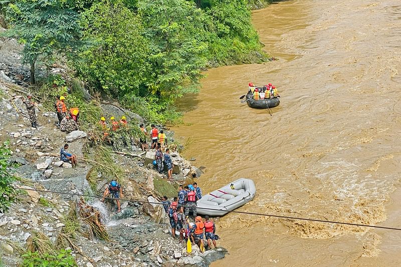 Rescuers search for survivors in river Trishuli in Simaltar on 12 July 2024, at the site of a landslide.