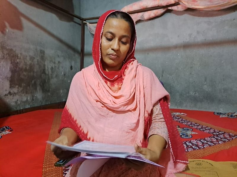 Garments worker Swapna Begum was showing educational certificates of her son Rahat Hossain, who was killed allegedly in police firing in Uttara on 18 July