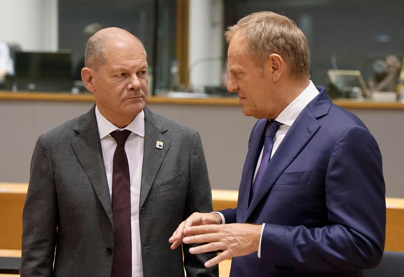 Germany’s Chancellor Olaf Scholz (L) talks with Poland's Prime Minister Donald Tusk ahead of the European Council Summit at the EU headquarters in Brussels on 27 June, 2024