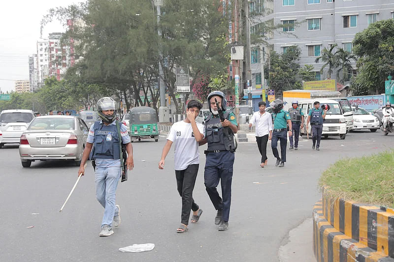 Police taking a protester away from ECB Chattar area on 29 July 2024.