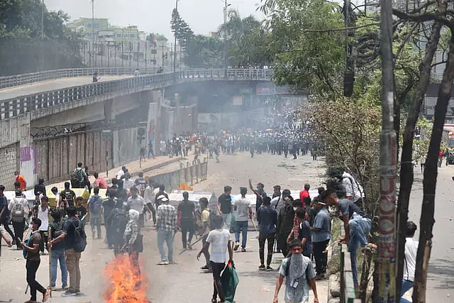 Protesters and police chase each other in Rampura area in Dhaka on Thursday, 18 July 2024.