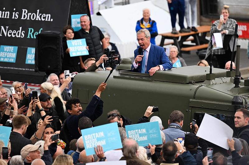 Leader of Reform UK Nigel Farage delivers a speech from the roof of a Land Rover during a general election campaign event by Clacton Pier, in Clacton, southeast England on 3 July, 2024