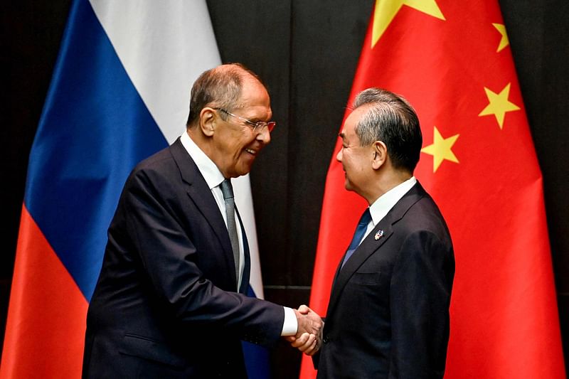 China's Foreign Minister Wang Yi (R) shakes hands with Russia's Foreign Minister Sergei Lavrov during a ministerial meeting on the sidelines of the 57th Association of southeast Asian Nations (ASEAN) Foreign Ministers' Meeting and Related Meetings in Vientiane on 25 July, 2024