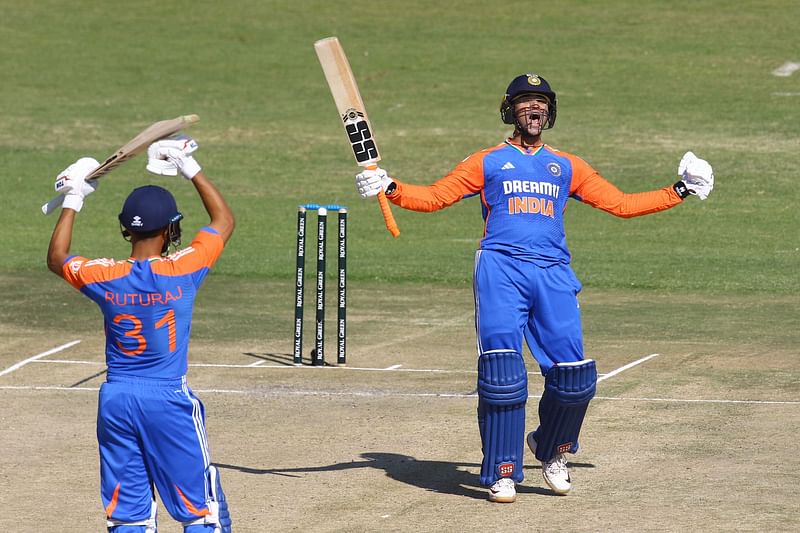 India's Abhishek Sharma (R) celebrates after scoring a century (100 runs) during the second T20 international cricket match between Zimbabwe and India at Harare Sports Club in Harare on 7 July, 2024