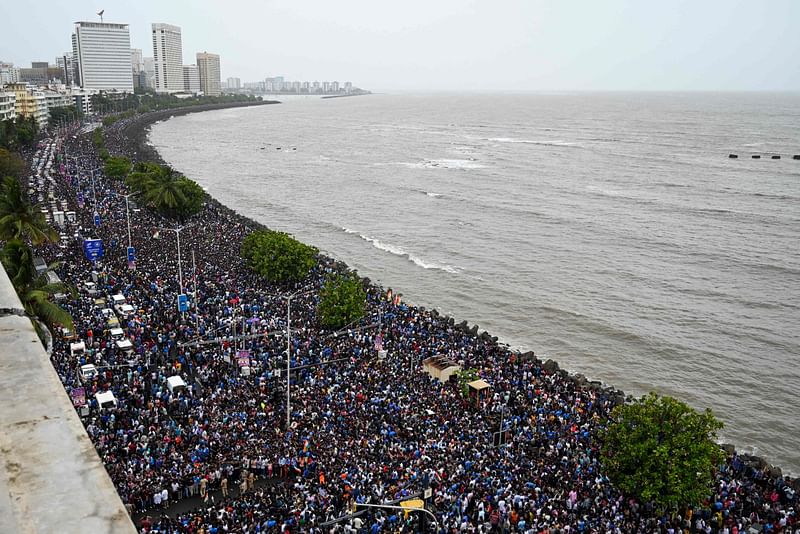 Fans gather at the Marine Drive seafront as they await the arrival of Indian cricket team in Mumbai on July 4, 2024, after winning the ICC men's Twenty20 World Cup in Barbados