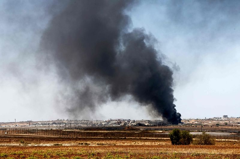 This picture taken from a position near Israel’s southern border with the Gaza Strip shows smoke rising over Gaza on 9 July, 2024, amid the ongoing conflict between Israel and the Palestinian militant group Hamas