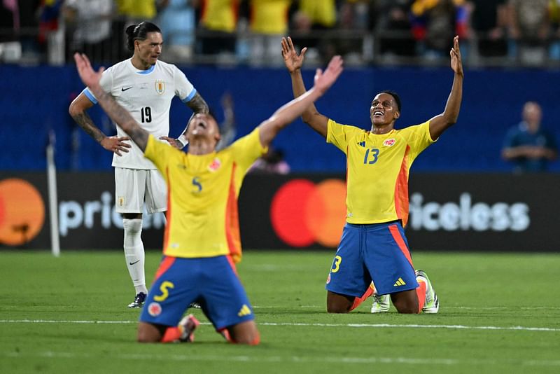 Colombia's midfielder #05 Kevin Castano and Colombia's defender Yerry Mina celebrate their team's victory in the Conmebol 2024 Copa America tournament semi-final football match