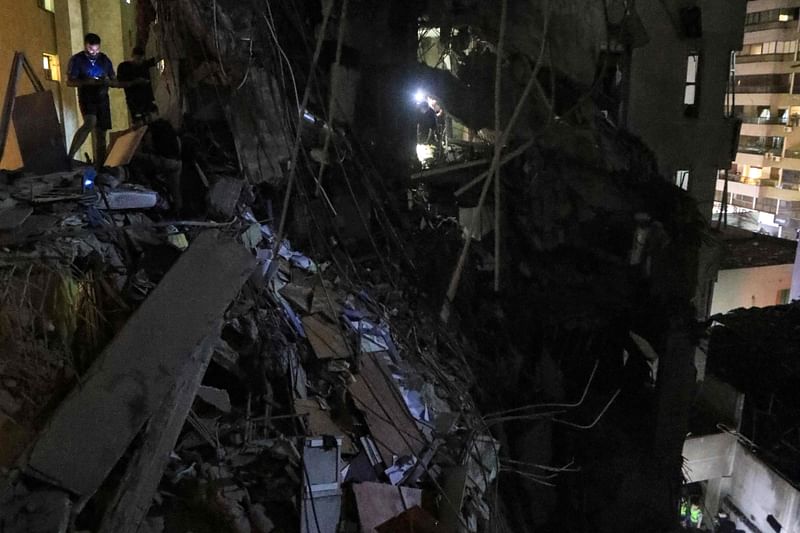 A man stands in the debris of the top floors of a partially destroyed building following an Israeli military strike in Beirut’s southern suburb on 30 July, 2024. Lebanon’s Prime Minister condemned an Israeli strike on Hezbollah’s stronghold in Beirut’s southern suburbs, days after Israel vowed to retaliate over deadly rocket fire from Lebanon on the occupied Golan Heights