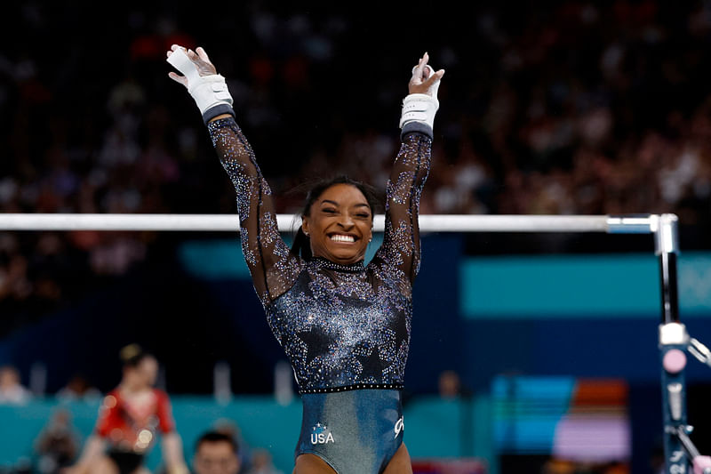 Paris 2024 Olympics - Artistic Gymnastics - Women's Qualification - Subdivision 2 - Bercy Arena, Paris, France - 28 July, 2024. Simone Biles of United States reacts after performing on the uneven bars.