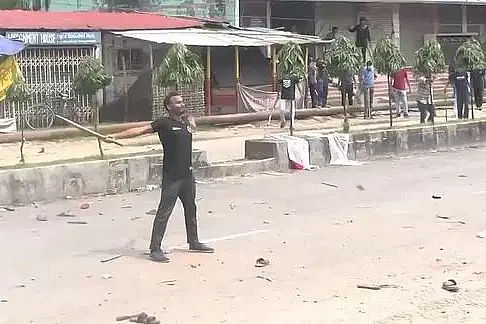 Abu Sayeed, a student of Rokeya University in Rangpur, widened his hands as police fired rubber bullets from a nearby position on 16 July. The photo is taken from vedio footage of Jamuna Television.