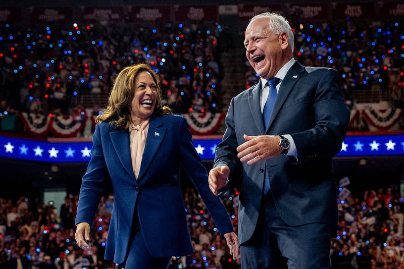 Democratic presidential candidate, U.S. Vice President Kamala Harris and Democratic vice presidential nominee Minnesota Gov. Tim Walz walk out on stage together during a campaign event on 6 August 2024 in Philadelphia, Pennsylvania.