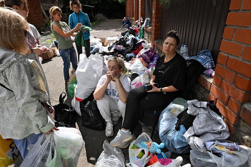 Local residents wait to be evacuated outside of the town of Sudzha on August 8, 2024. Ukraine's incursion into Russia, which entered a third day on 8 August, 2024