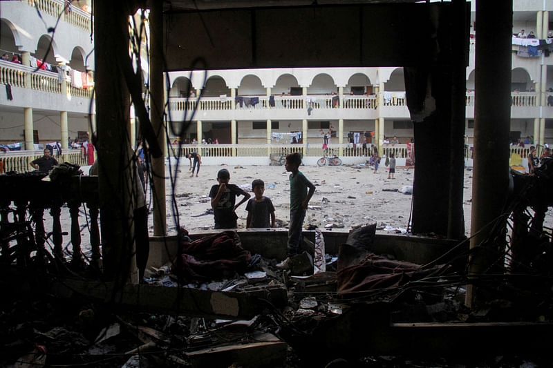 Palestinians look at the damage at the site of an Israeli strike on a school sheltering displaced people, amid the Israel-Hamas conflict, in Gaza City August 10, 2024