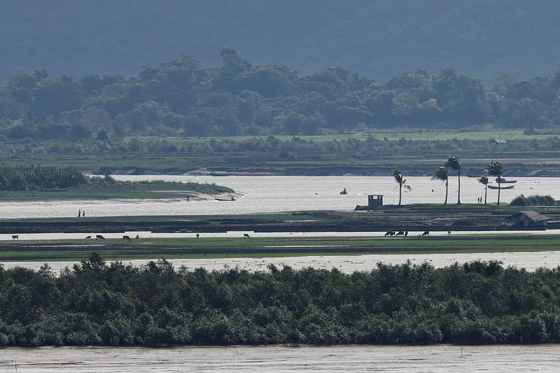 People of Maungdaw township of Myanmar are seen from the Teknaf area of Bangladesh, at the Myanmar-Bangladesh border, during the ongoing conflict in the Rakhine state of Myanmar, in Cox's Bazar, Bangladesh, 27 June 2024.