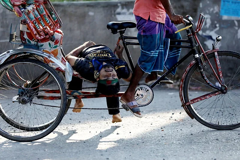 Golam Nafiz, who had been shot, was laid on the footrest of a rickshaw and he was still holding on to the frame of the rickshaw with one of his hands. His parents found his body looking at this photo taken by daily Manab Zamin photo journalist Jibon Ahmed.