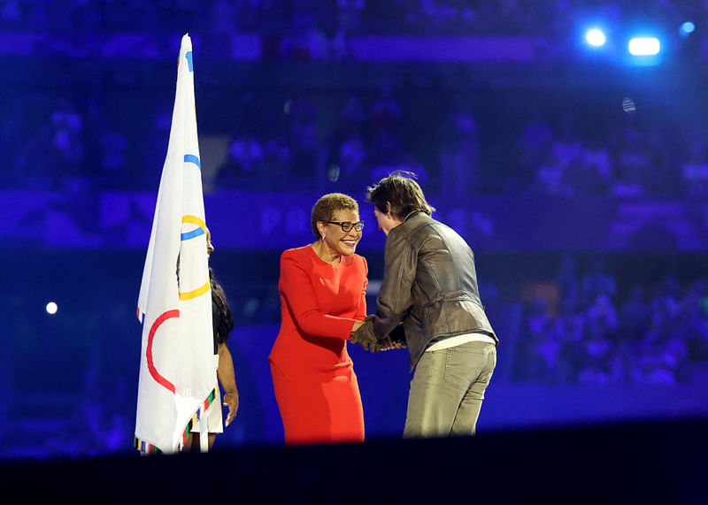 Actor Tom Cruise shakes hands with the Mayor of Los Angeles Karen Bass during the closing ceremony on Paris Olympics