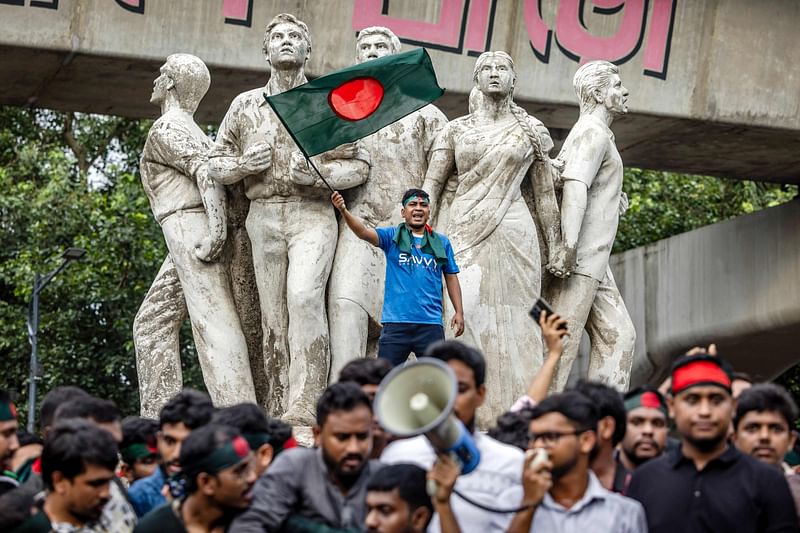 A student (C) waving Bangladesh’s national flag, chants slogans during a protest to demand accountability and trial against the country’s ousted Prime Minister Sheikh Hasina, near Dhaka University in the capital on 12 August, 2024. Bangladesh was experiencing a “student-led revolution” after the ouster of premier Sheikh Hasina, the South Asian country’s new interim leader Muhammad Yunus said