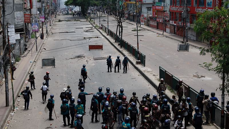 Members of Border Guard Bangladesh (BGB) and the police work to control the protesters outside the state-owned Bangladesh Television as violence erupts after anti-quota protests by students, in Dhaka, Bangladesh, on 19 July 2024