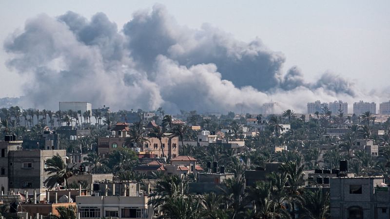 A picture taken from Deir el-Balah shows smoke billowing after an Israeli strike on Khan Yunis on 16  August, 2024, amid the ongoing conflict between Israel and the Hamas militant group