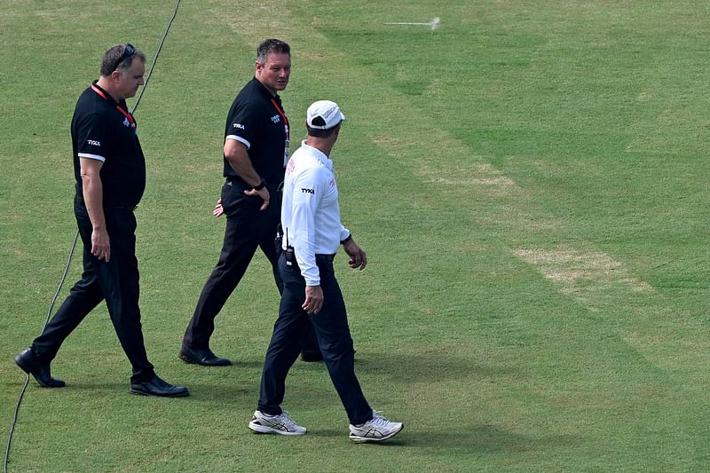 Umpires Richard Kettleborough of England (C) and Adrian Holdstock of South Africa (L) inspect the pitch at the Rawalpindi Cricket Stadium in Rawalpindi on 21 August 2024, for first Test cricket match between Pakistan and Bangladesh.