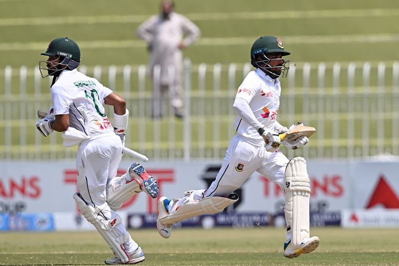 Bangladesh's Shadman Islam (L) and Mominul Haque run between the wickets during the third day of first Test cricket match between Pakistan and Bangladesh at the Rawalpindi Cricket Stadium in Rawalpindi on 23 August 2024.