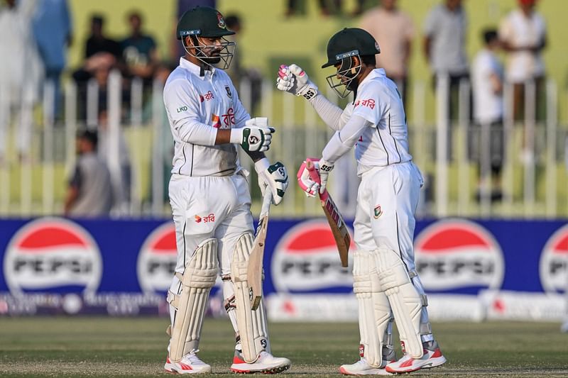 Bangladesh's Litton Das and Mushfiqur Rahim (R) bump their fists during the third day of the first Test cricket match between Pakistan and Bangladesh at the Rawalpindi Cricket Stadium in Rawalpindi on 23 August 2024.