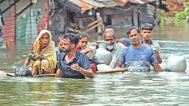 A family moves to shelter in the Khaiara Bazar area of Feni on Friday