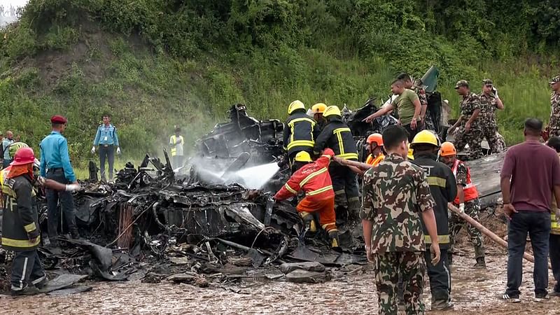 Fire services and Nepal Police personnel at the Tribhuvan International Airport where a plane crashed claiming the lives of 41 people, in Kathmandu on Wednesday