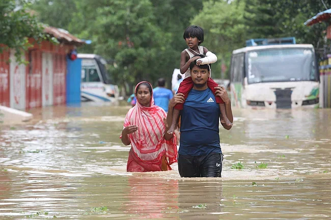 Tabassum, a six-year-old child, got her hand fractured. She is heading towards hospital for treatment, along with her mother and uncle. The photo was taken from the Fazilpur area of Feni on 24 August, 2024.