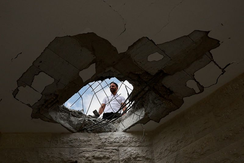 An official property surveyor assesses the damage to a residential building following a direct-hit from a projectile, after Hezbollah launched hundreds of rockets and drones towards Israel in what the Iranian-backed movement said was a response to the assassination of a senior commander in Beirut last month, in northern Israel on 25 August 2024.