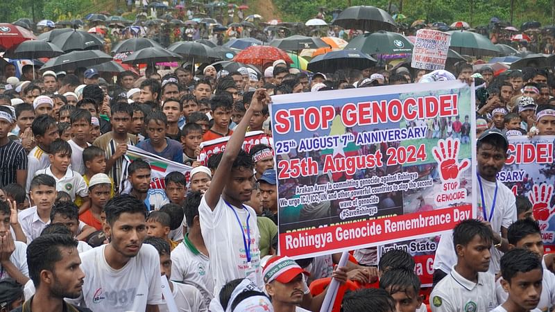 Rohingya refugees gather to mark the seventh anniversary of their fleeing from neighbouring Myanmar to escape a military crackdown in 2017, during heavy monsoon rains in Cox's Bazar, Bangladesh, on 25 August 2024