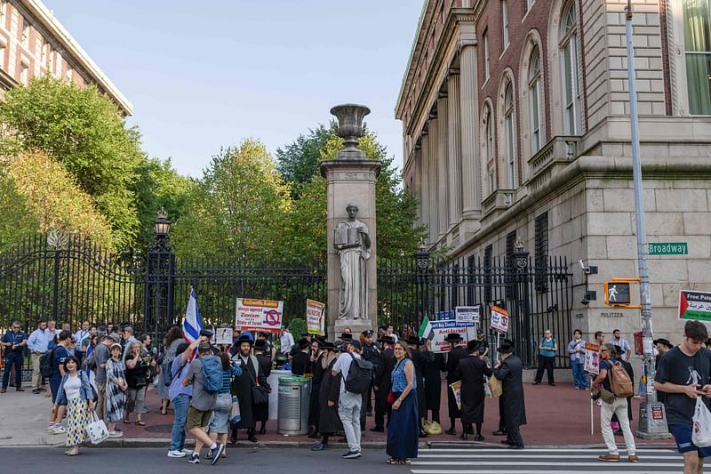 Members of the Haredi Jewish group Neturei Karta counter protest as people attend a demonstration, organised by the group End Jew Hatred outside of Columbia University, to call for a new mask ban in New York after an escalating spate of anti-Semitic protests staged by face-concealed mobs in New York on 27 August 2024.