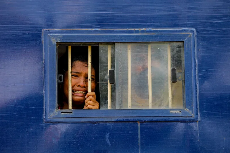 A detained protester cries inside a police prison van. Photo taken near Royal Mor intersection in Khulna on 31 July 2024.