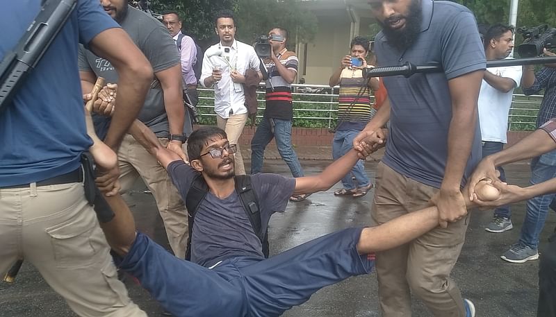 Law enforcers carry a student sprawled out at Rajshahi University on 1 August