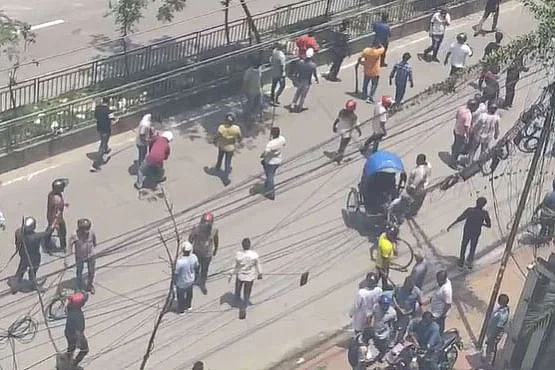 Awami League leaders and activists chase protestors at Dhanmondi Road 27 in the capital city today, Sunday