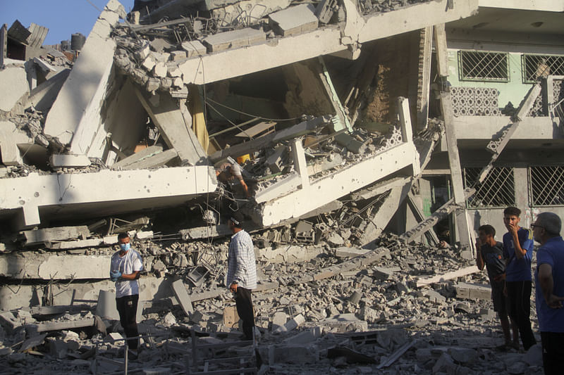 Palestinians inspect the site of Israeli strikes on a school sheltering displaced people, amid Israel-Hamas conflict, in Gaza City, 4 August, 2024.