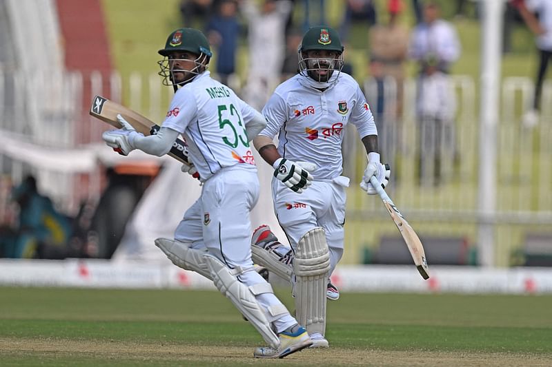 Bangladesh's Liton Das (R) and Mehidy Hasan Miraz run between the wickets during the third day of the second and last Test cricket match between Pakistan and Bangladesh, at the Rawalpindi Cricket Stadium in Rawalpindi on 1 September 2024.