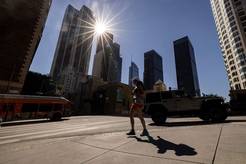 A pedestriansp crosses a street in downtown Los Angeles on 4 September, 2024, as Southern California faces a heat wave. Californians were being warned on 3 September to prepare to swelter as a fearsome heatwave settles over the western US state. The mercury was forecast to top out at a scorching 113F (45C) in parts of Los Angeles later in the week, marking the high point of an already hot summer.