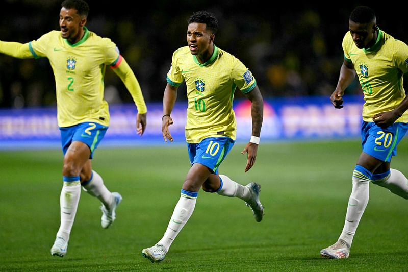 Brazil's forward Rodrygo celebrates with teammates defender Danilo (L) and forward Luiz Henrique after scoring during the 2026 FIFA World Cup South American qualifiers football match between Brazil and Ecuador, at the Major Antônio Couto Pereira stadium in Curitiba, Brazil, on 6 September, 2024.