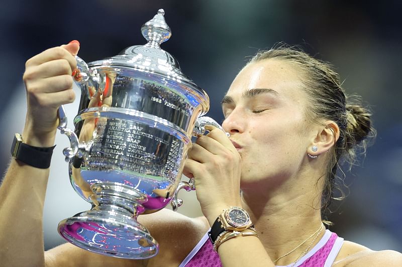 Belarus's Aryna Sabalenka kisses the trophy after defeating USA's Jessica Pegula during their women's final match on day thirteen of the US Open tennis tournament at the USTA Billie Jean King National Tennis Center in New York City, on 7 September, 2024.