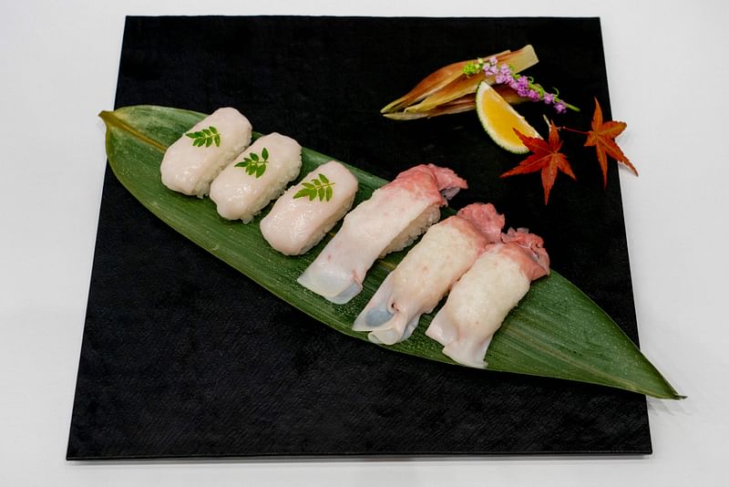 A plate of sushi made from raw fin whale meat is displayed at the exhibition and business meeting of domestically produced fin whales hosted by Japan's whaling company Kyodo Senpaku at Tokyo's Toyosu market on 13 September 2024.