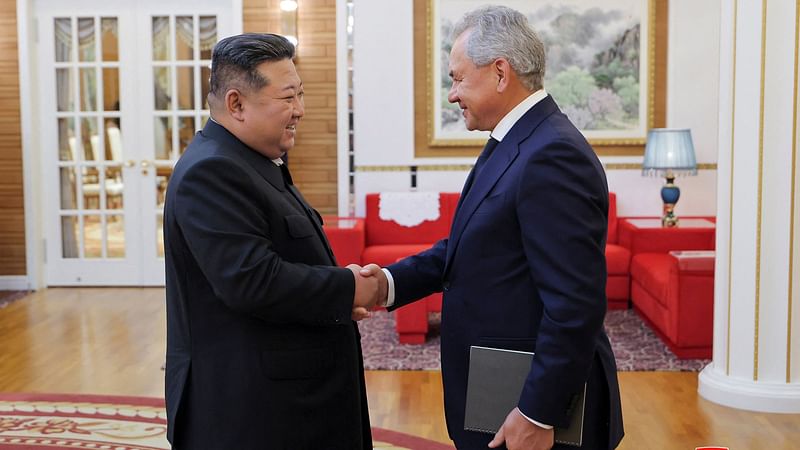 North Korea's leader Kim Jong Un (L) meeting with Russia's Security Council Secretary Sergei Shoigu at an undisclosed location in North Korea