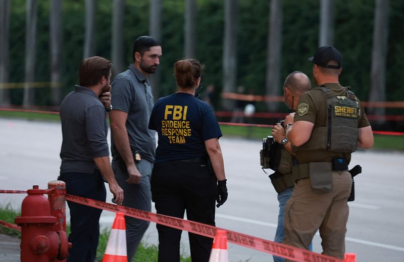 Law enforcement personnel investigate the area around Trump International Golf Club after an apparent assassination attempt of former President Donald Trump on September 15, 2024 in West Palm Beach, Florida