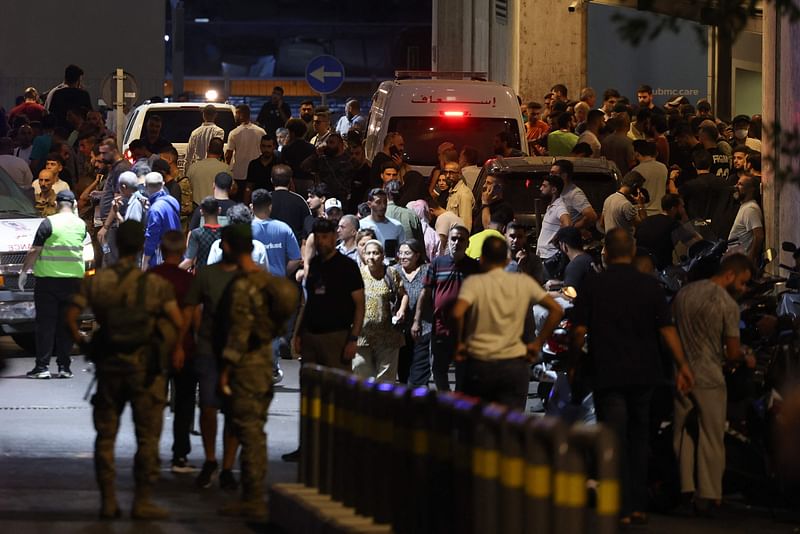 People gather at the entrance of the American University of Beirut Medical Center, on 17 September, 2024, after explosions hit locations in several Hezbollah strongholds around Lebanon amid ongoing cross-border tensions between Israel and Hezbollah fighters.