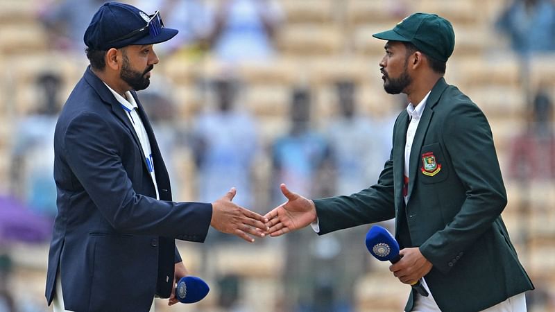 India's captain Rohit Sharma (L) prepares to shake hands with his Bangladesh's counterpart Najmul Hossain Shanto before the start of the first day play of the first Test cricket match between India and Bangladesh at the M.A. Chidambaram Stadium in Chennai on 19 September, 2024