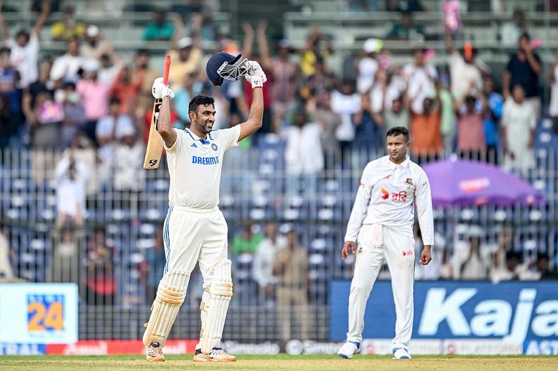 India's Ravichandran Ashwin (L) celebrates after scoring a century (100 runs) as Bangladesh' Shakib Al Hasan watches during the first day of the first Test cricket match between India and Bangladesh at the M.A. Chidambaram Stadium in Chennai on September 19, 2024.